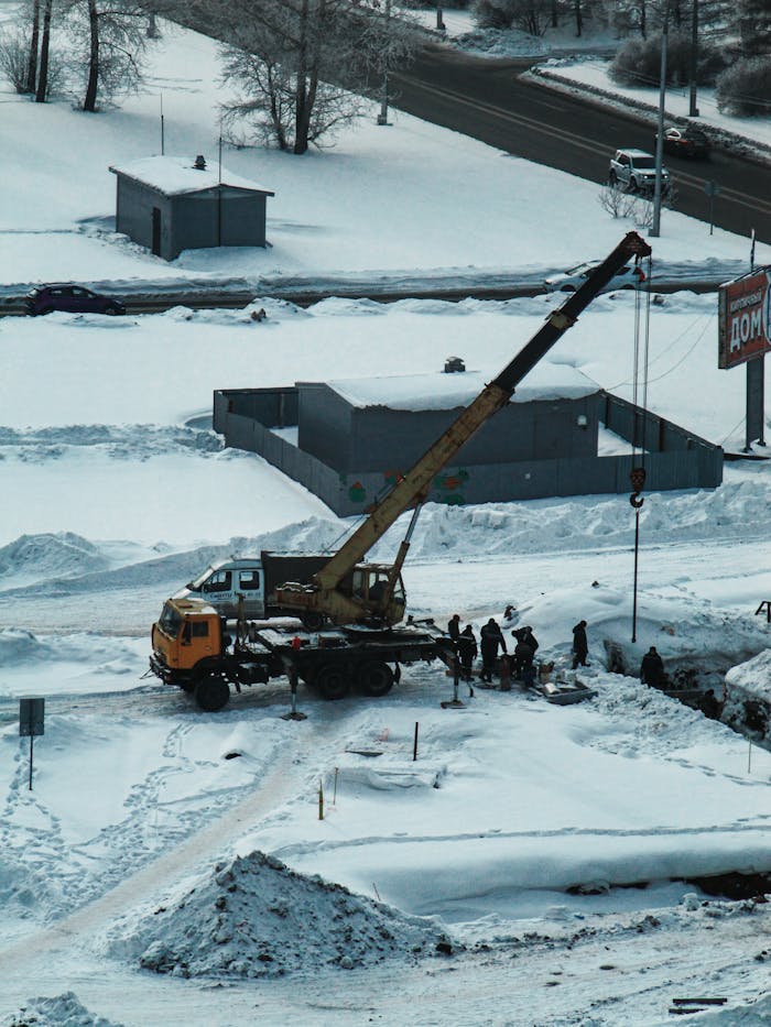 Mastering the First Impression: Your intriguing post title goes here A construction crew works with heavy machinery in a snowy outdoor setting, showcasing winter industry challenges.