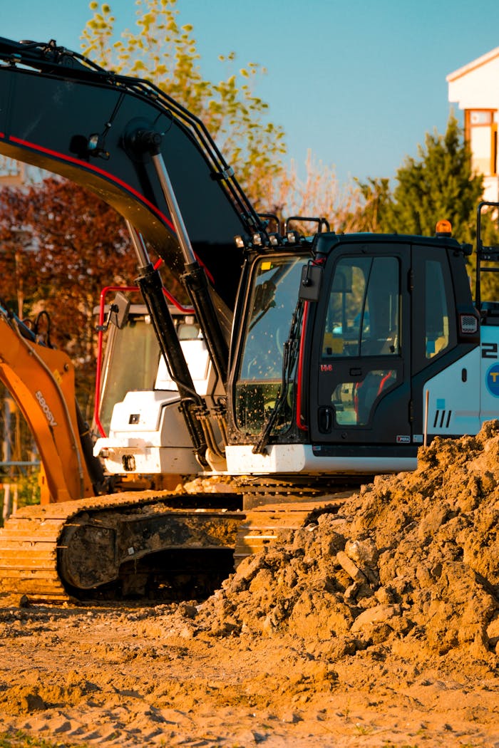 Crafting Captivating Headlines: Your awesome post title goes here Excavator at a construction site with dirt piles and trees in background.